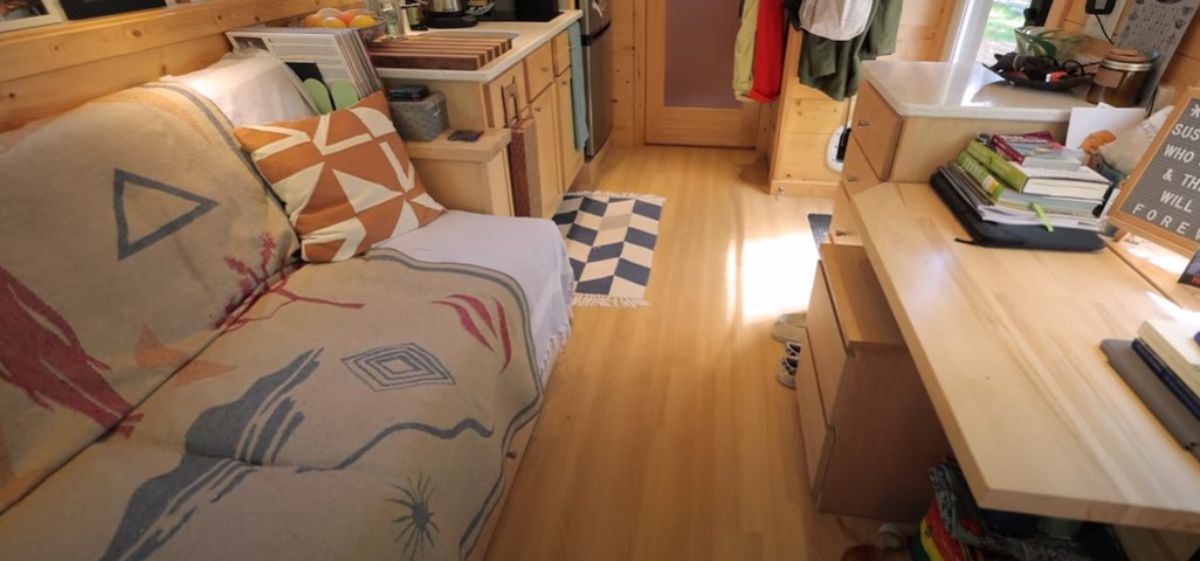 wood floors with checked rug by sink