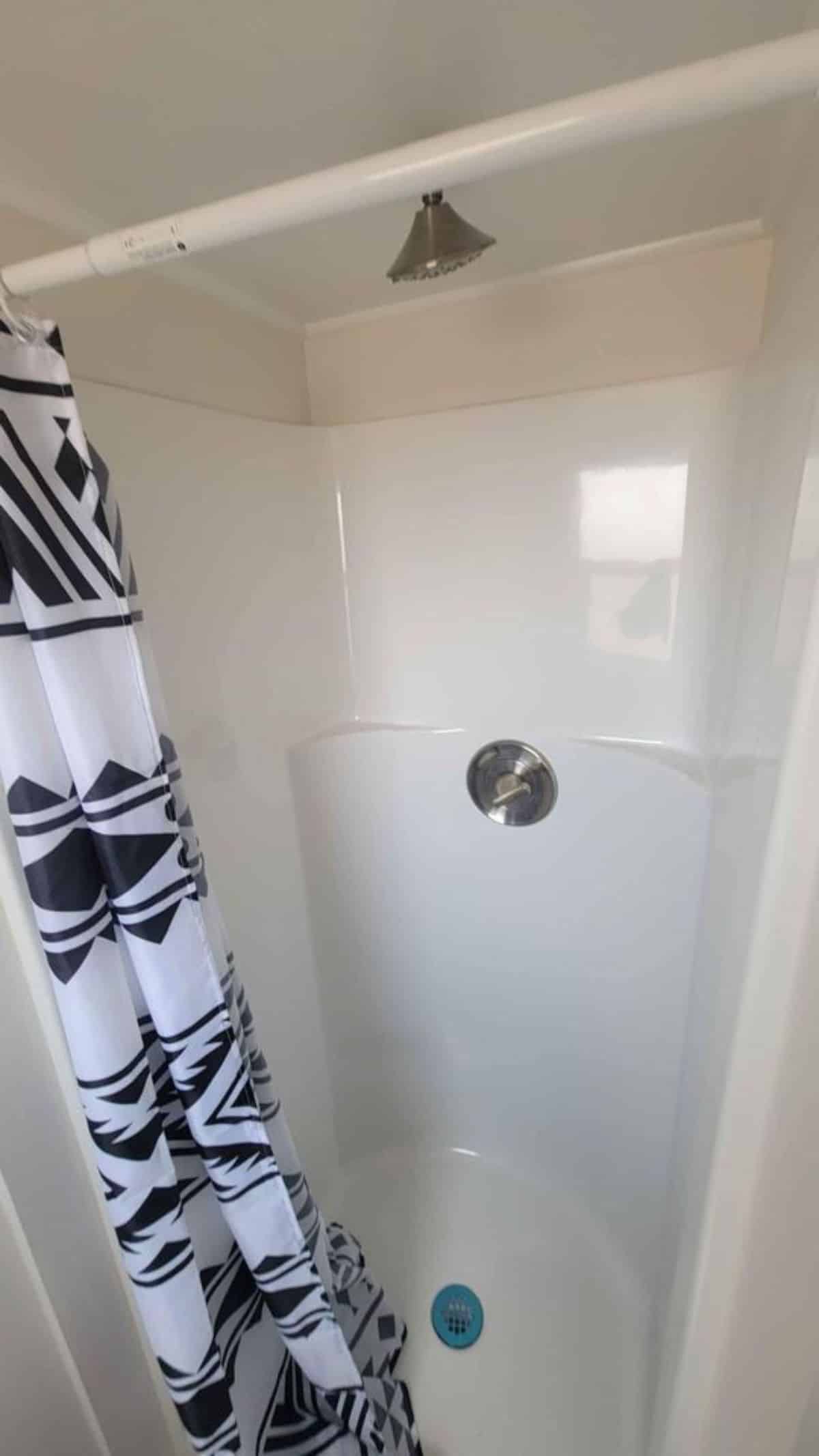 Separate shower area in bathroom of 14’ compact tiny house