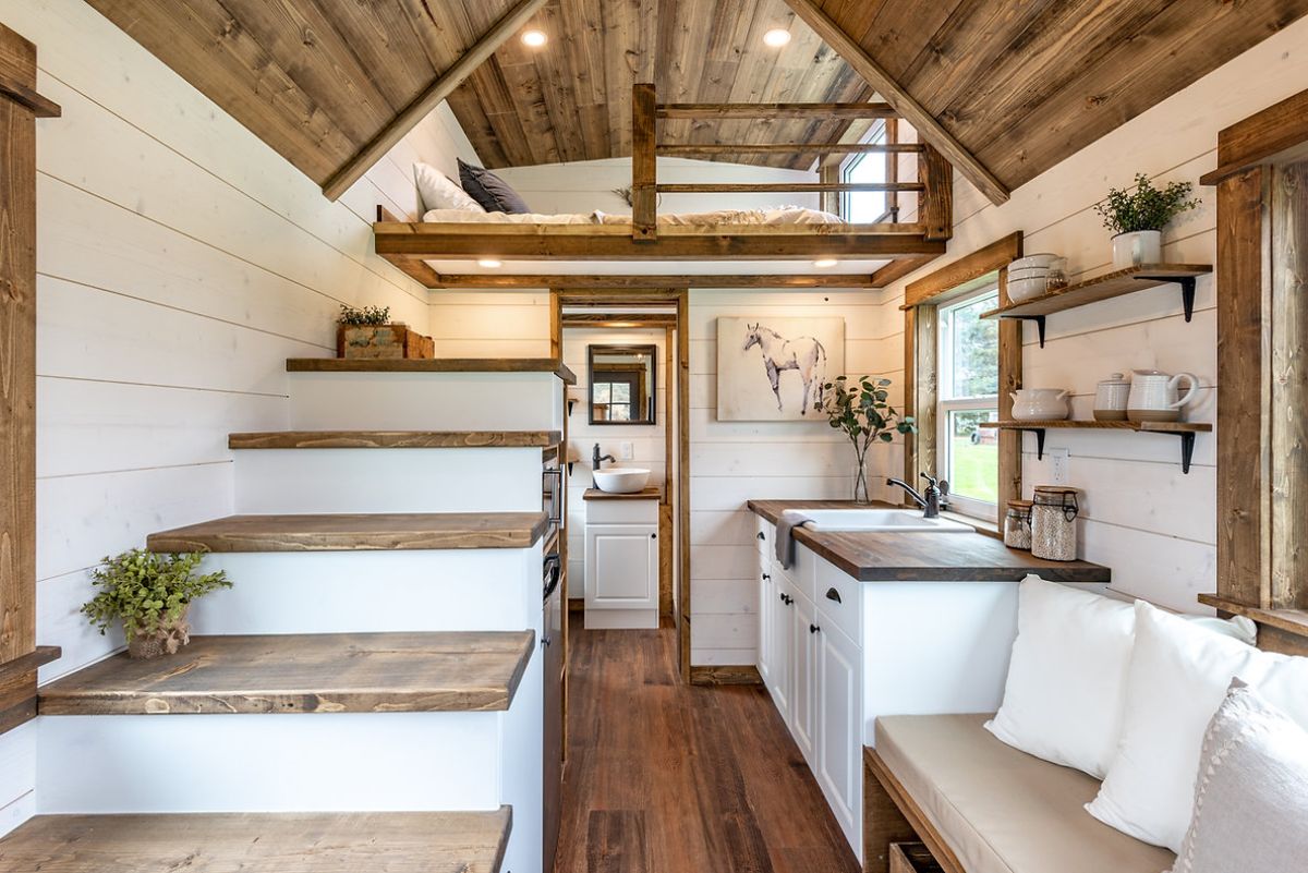 white steps and cabinets in tiny home with wood accents