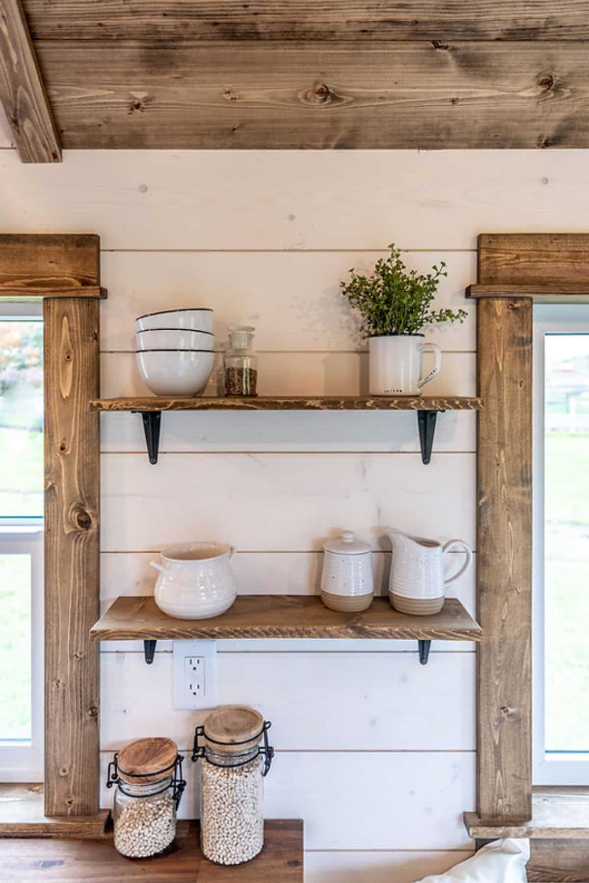 floating shelves in between windows in tiny home kitchen
