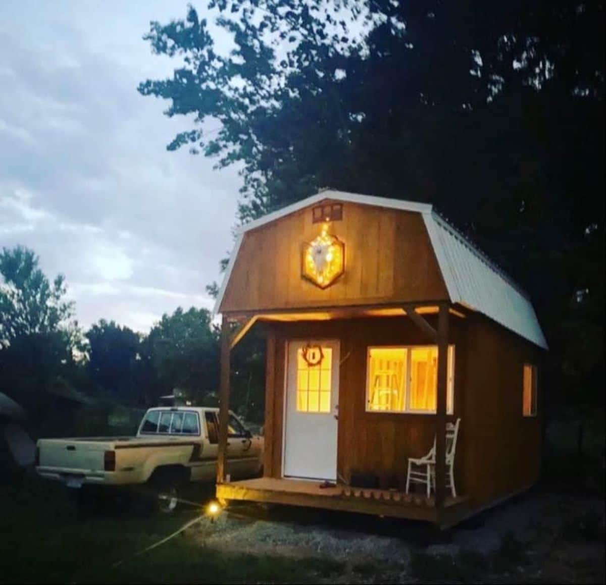Stunning 20’ barn style tiny home at night