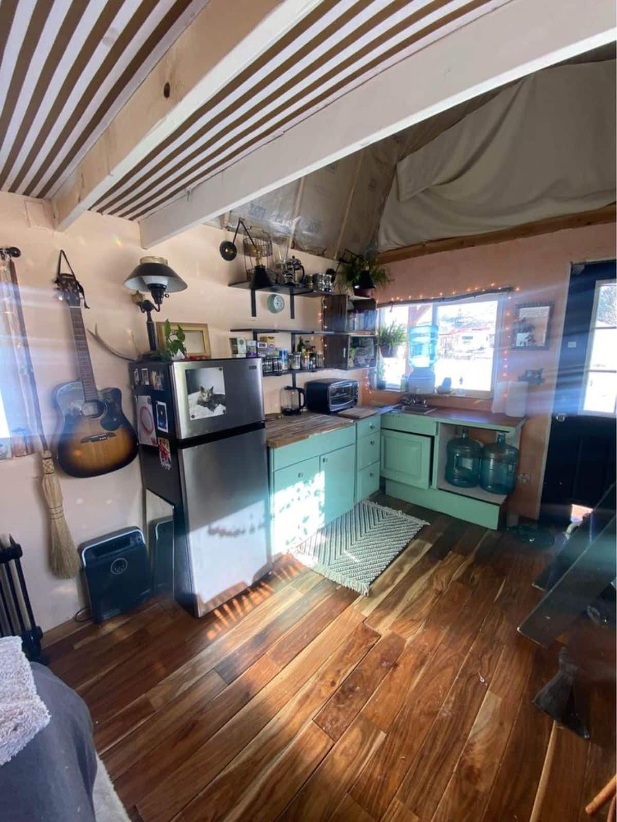 L shaped kitchen area of of 20’ barn style tiny home