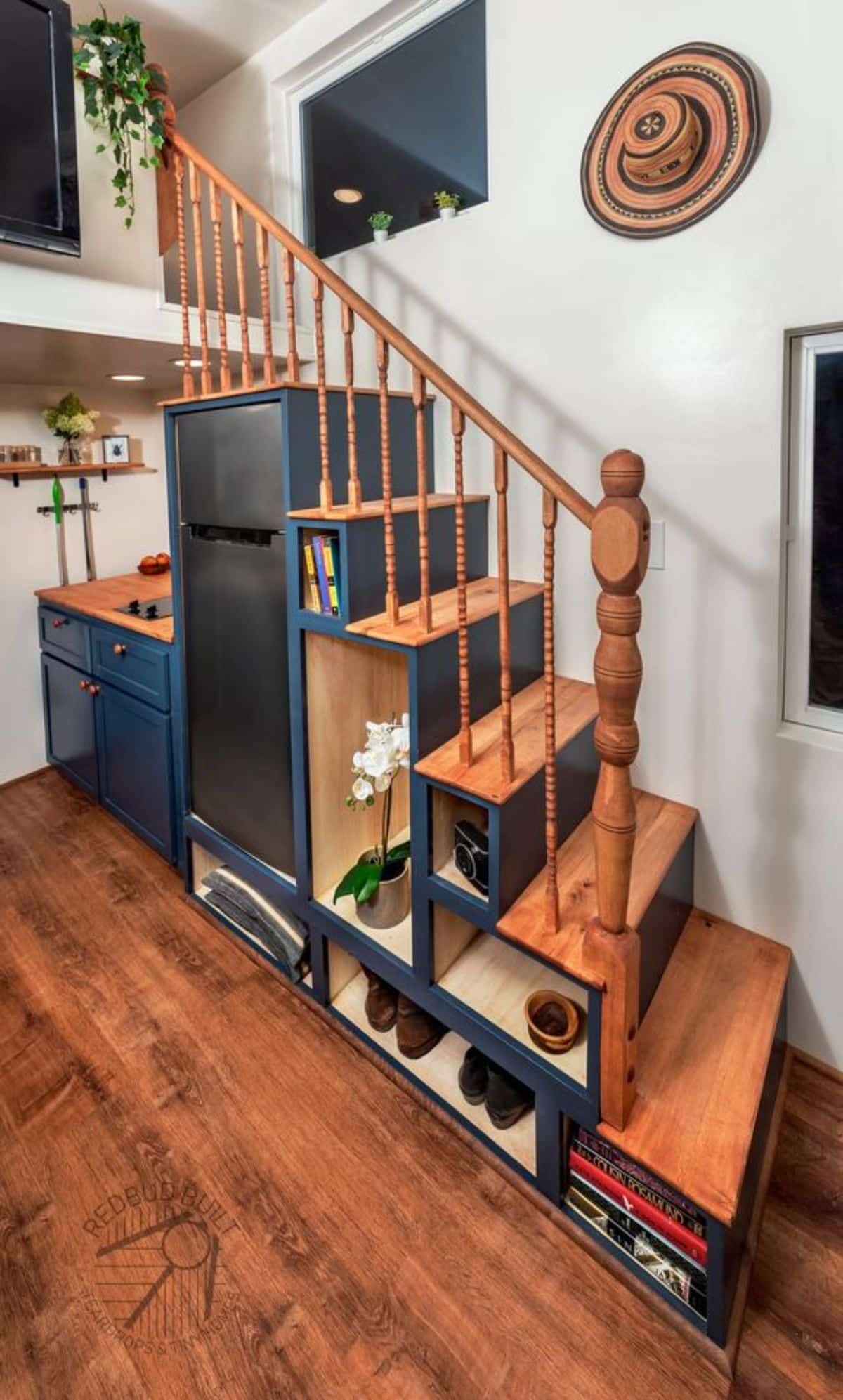 Multi purpose stairs with refrigerator underneath and other storage cabinets