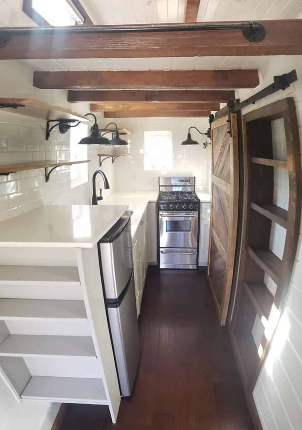 Kitchen area of tiny house with two lofts