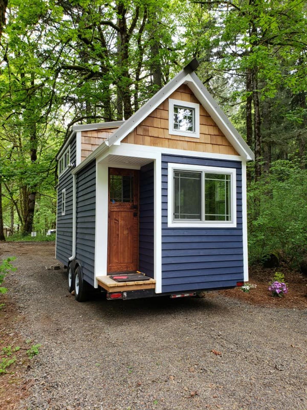 Main entrance and stunning exterior of tiny house with two lofts