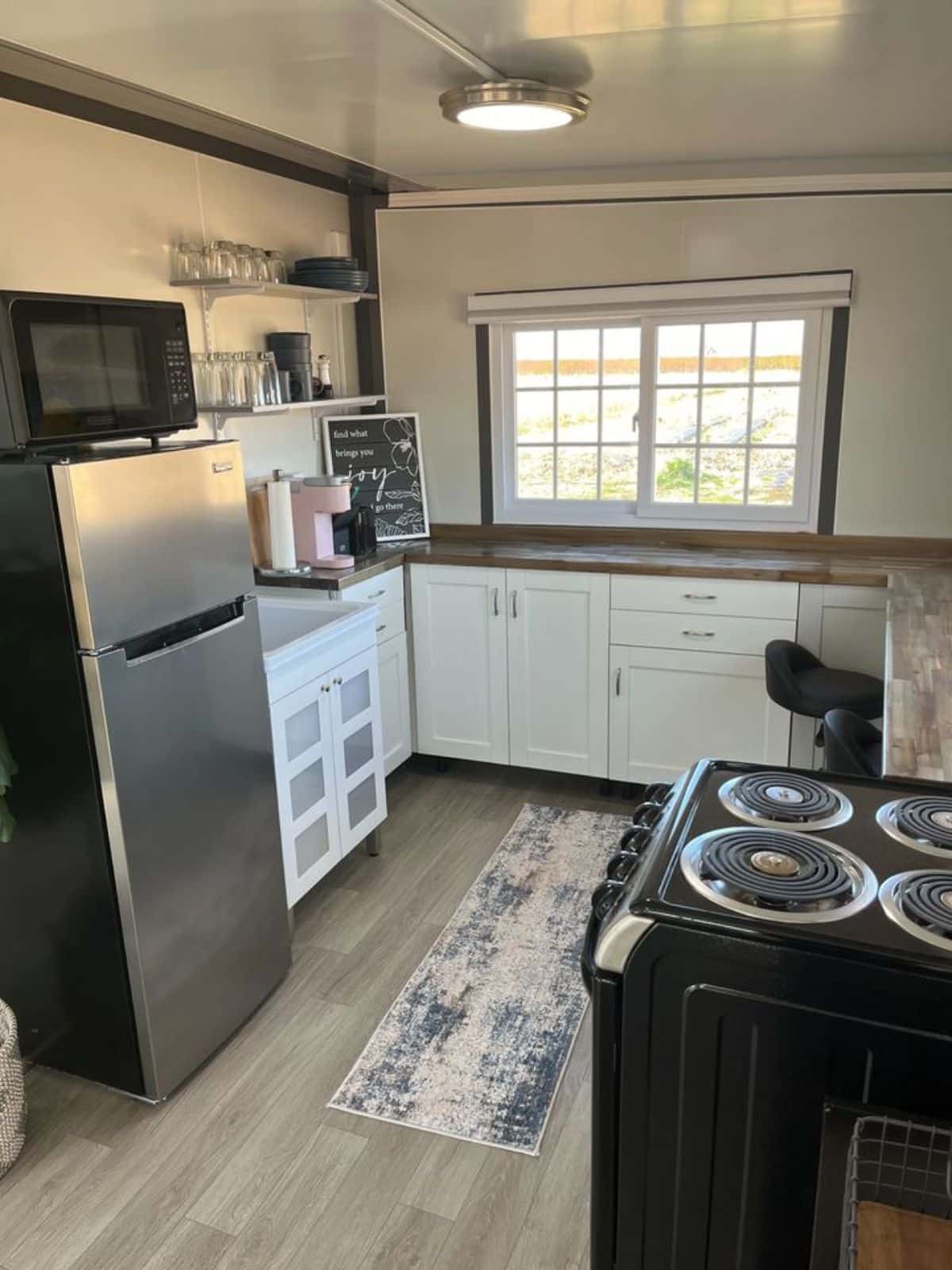 Huge counter top with storage cabinets and stove on the other side of kitchen