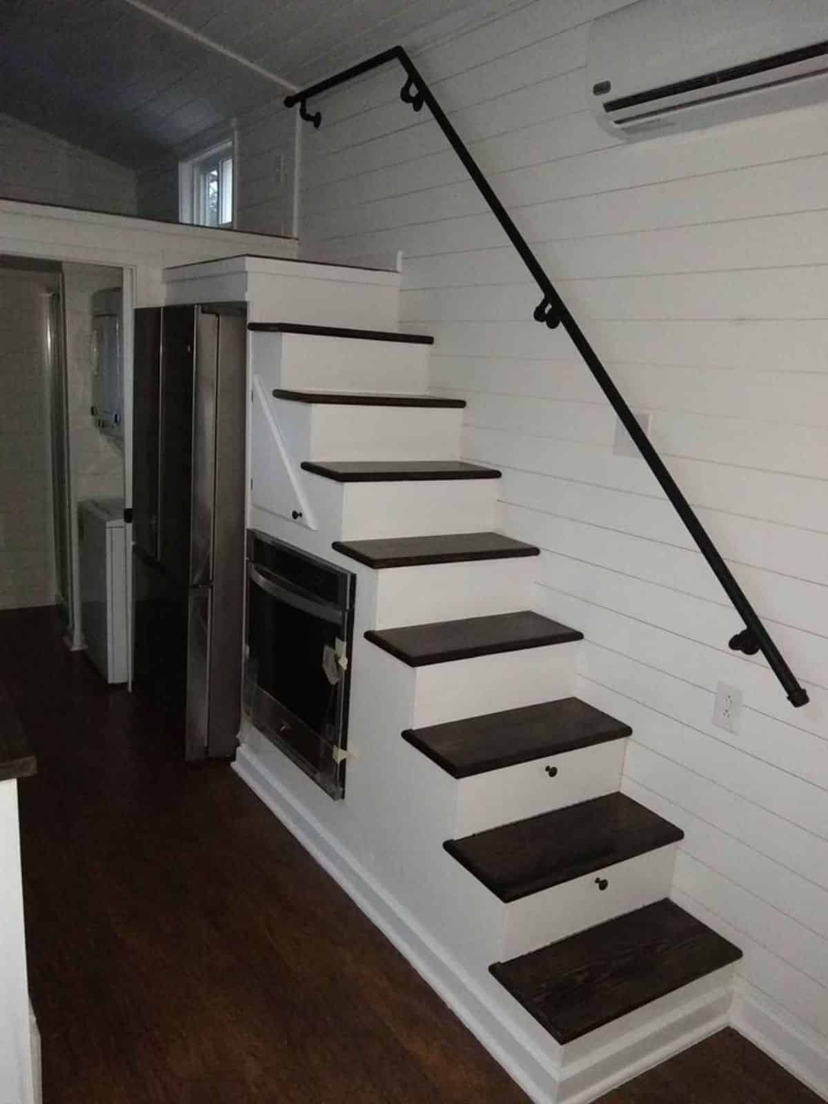 Multi purpose stairs leading to the loft bedroom of 24’ custom tiny house