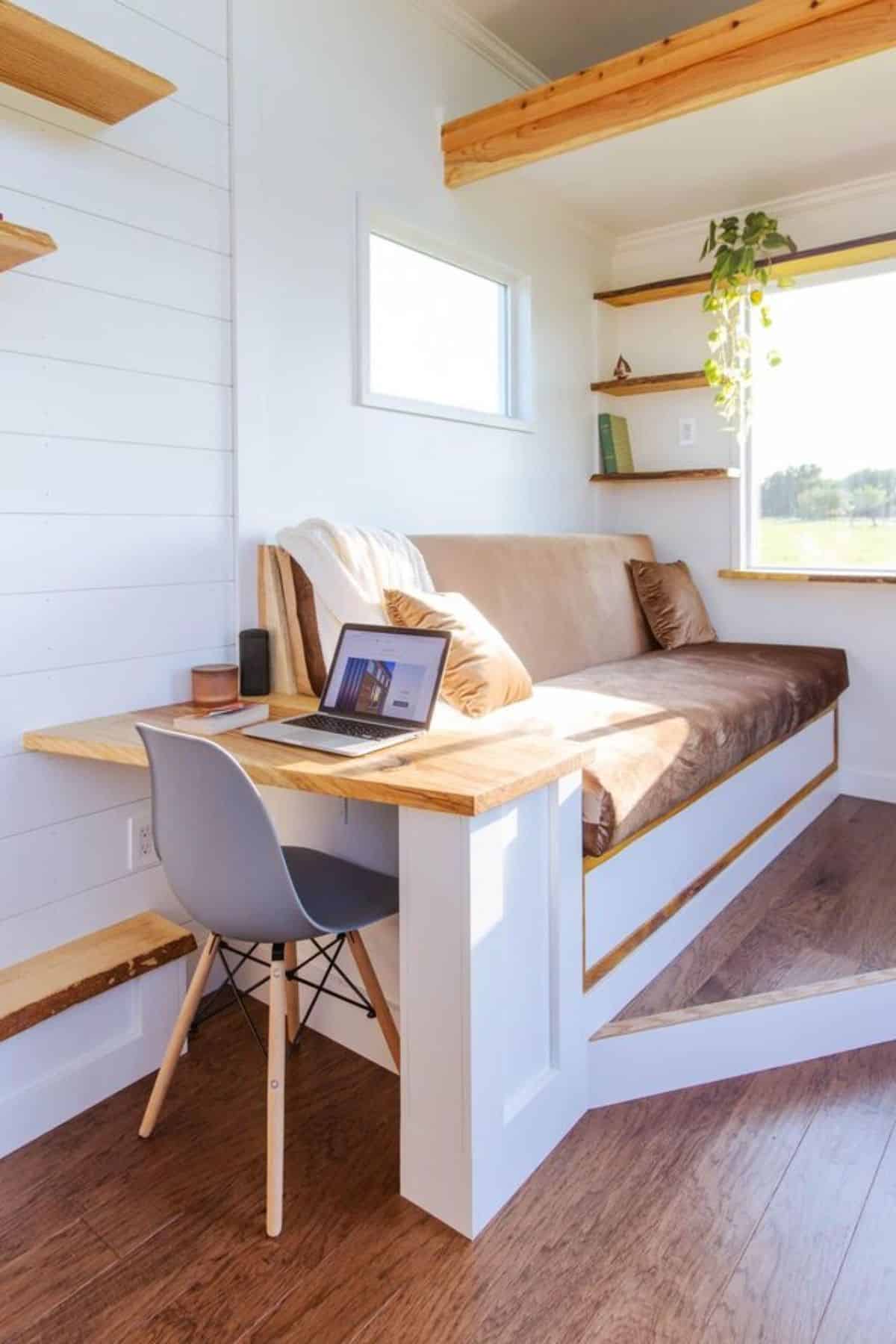 Comfortable and convertible couch in living area of one bedroom tiny home