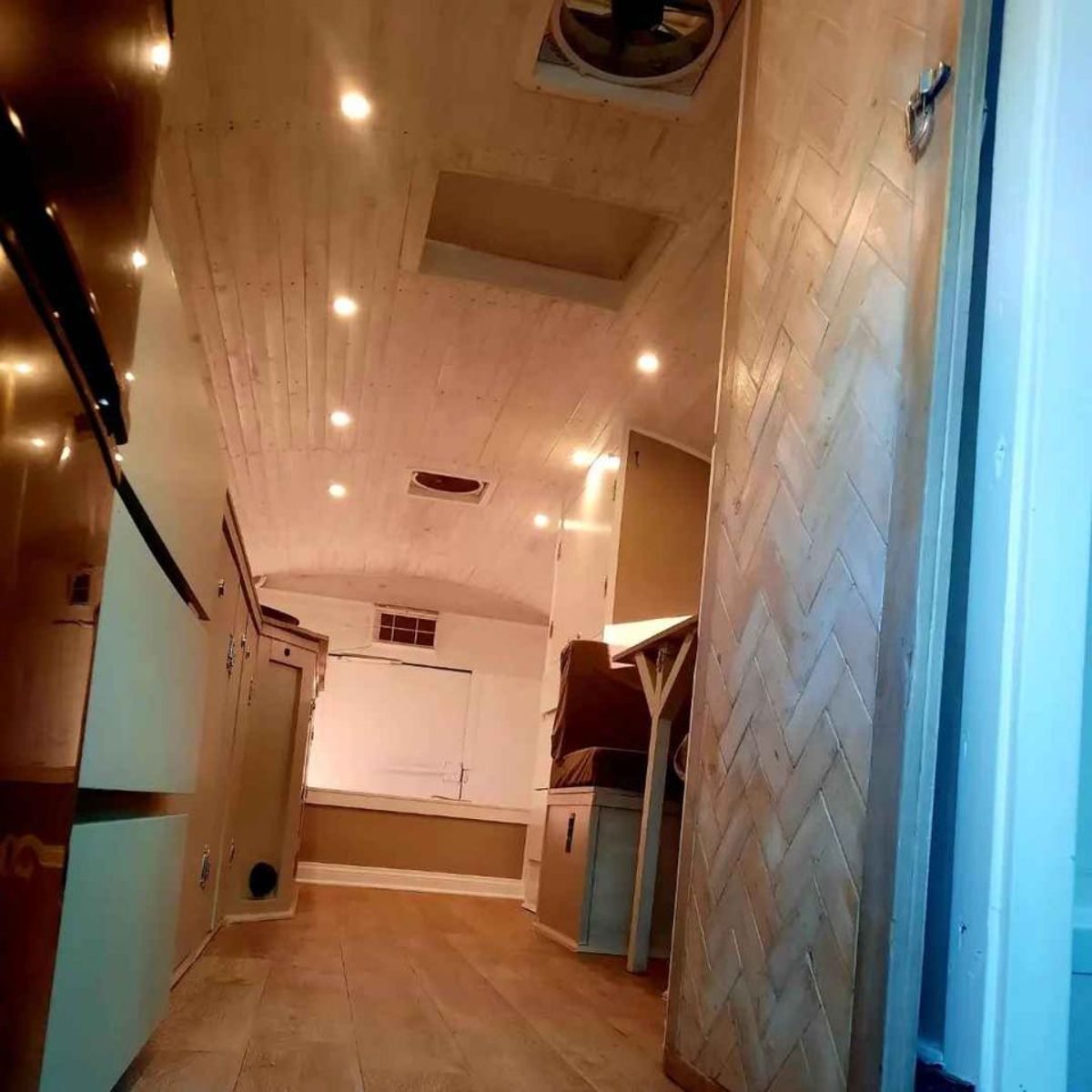 Wooden flooring and led rights are installed all over the converted tiny home