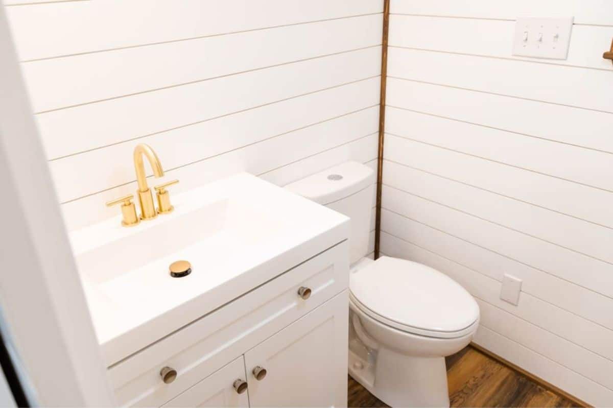 White styled bathroom of 34’ custom built tiny home
