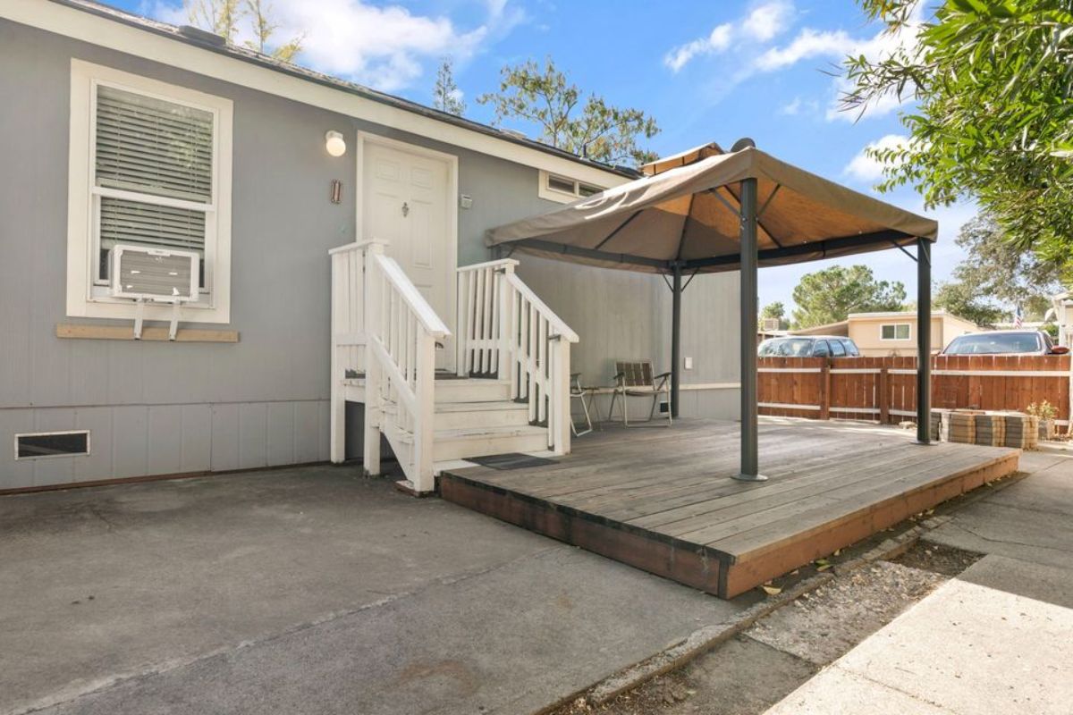 Main entrance view of tiny home with a patio