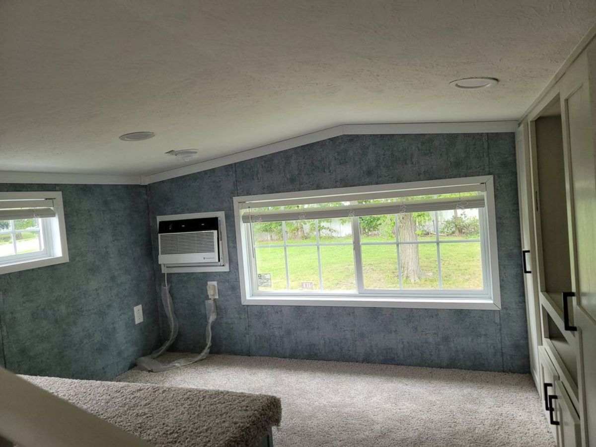Huge window and an air condition unit is installed in bedroom of 399 sf park model tiny home