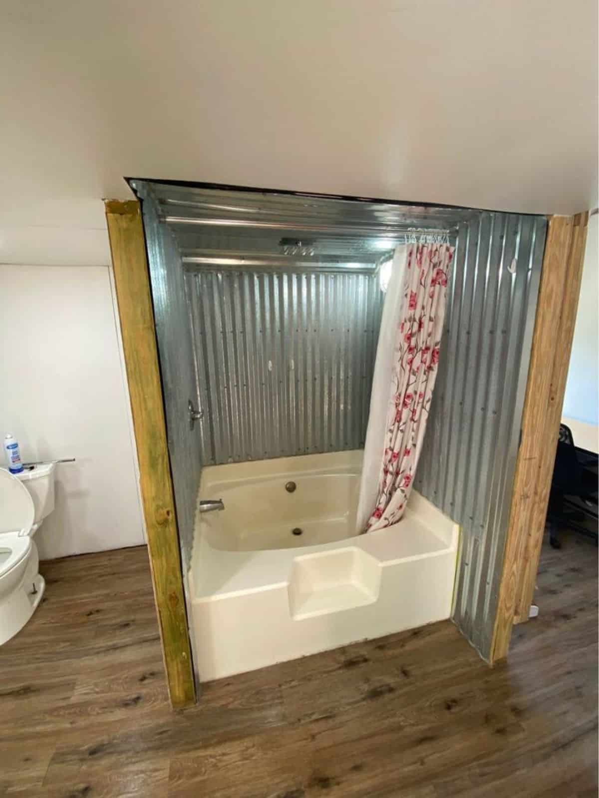 Bathtub in bathroom of 40’ shed converted tiny home