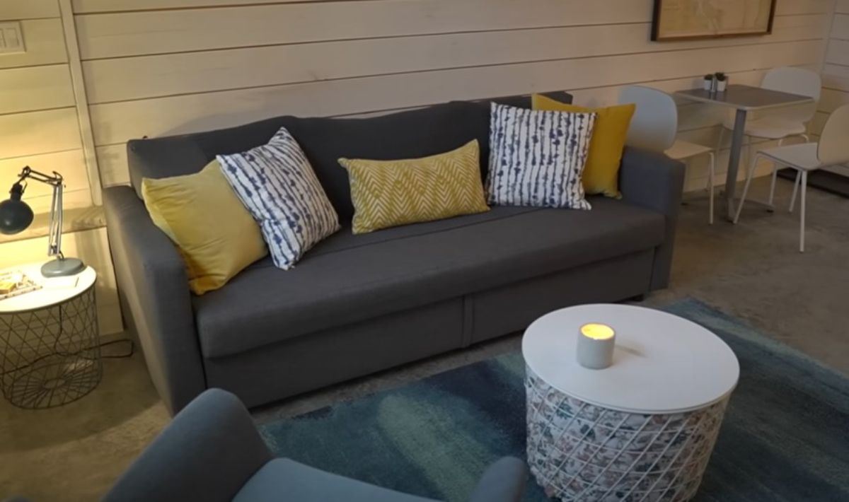 gray sofa with yellow and white cushions