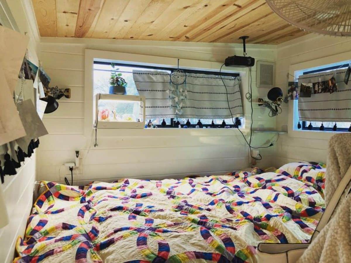 colorful bedding on bed in loft