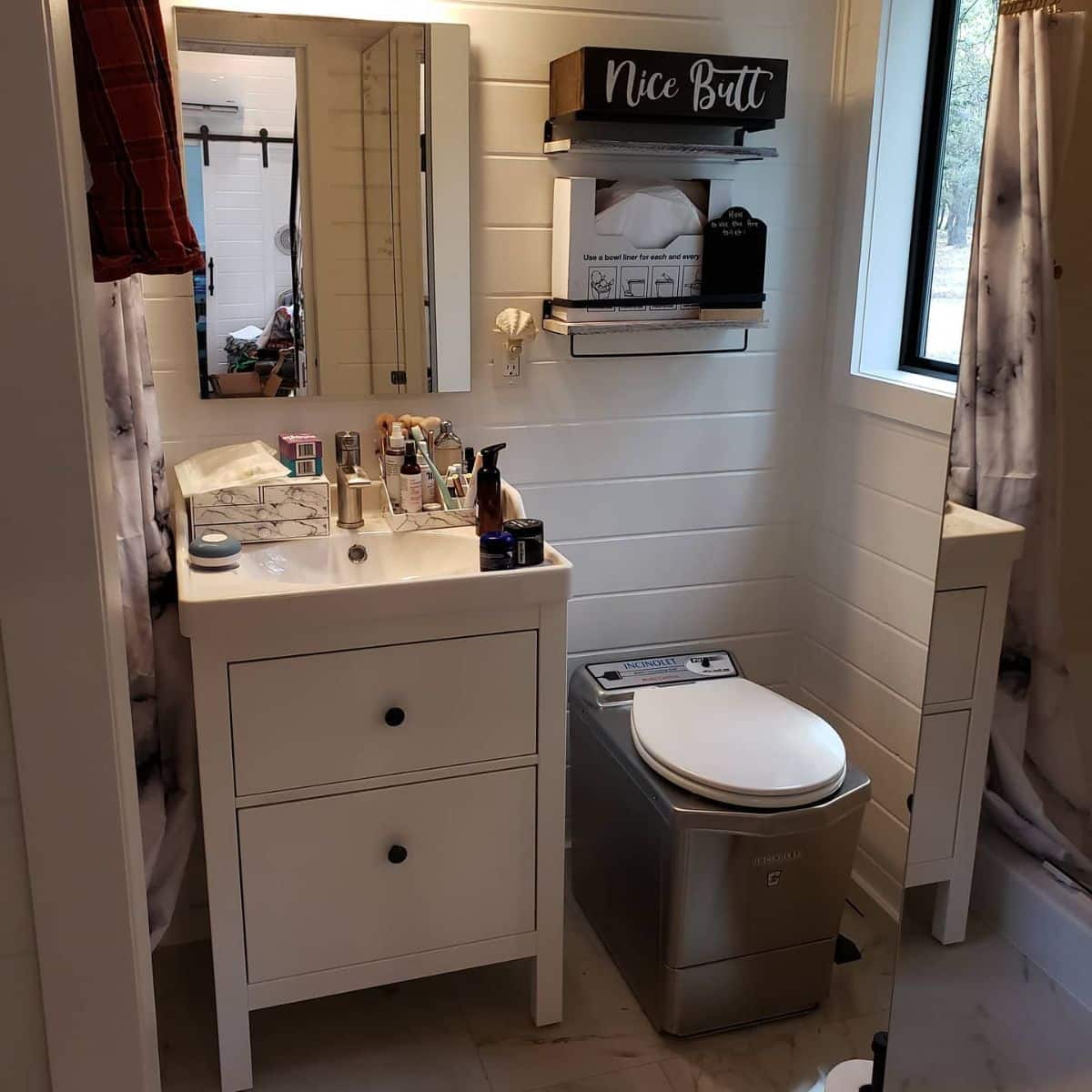 bathroom with compost toilet beside white vanity and sink