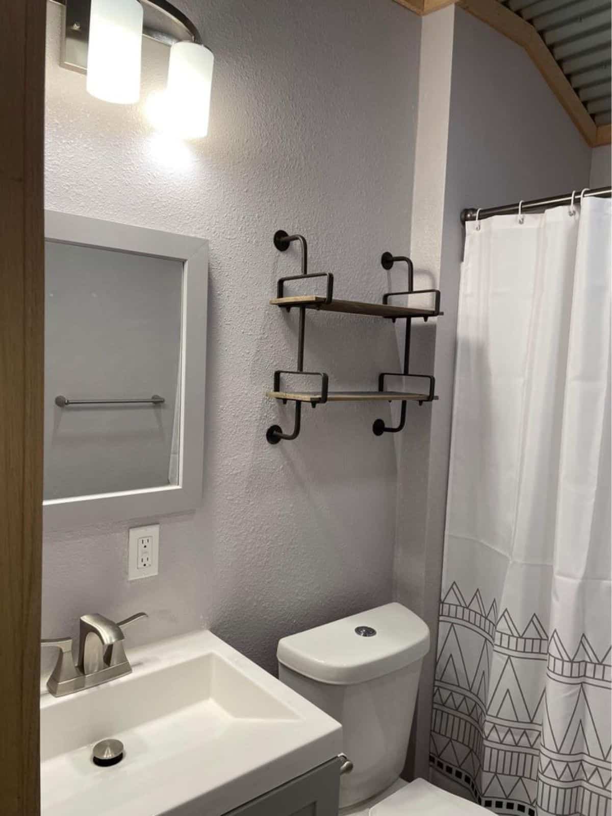 Bathroom of spacious tiny home has all the standard fittings