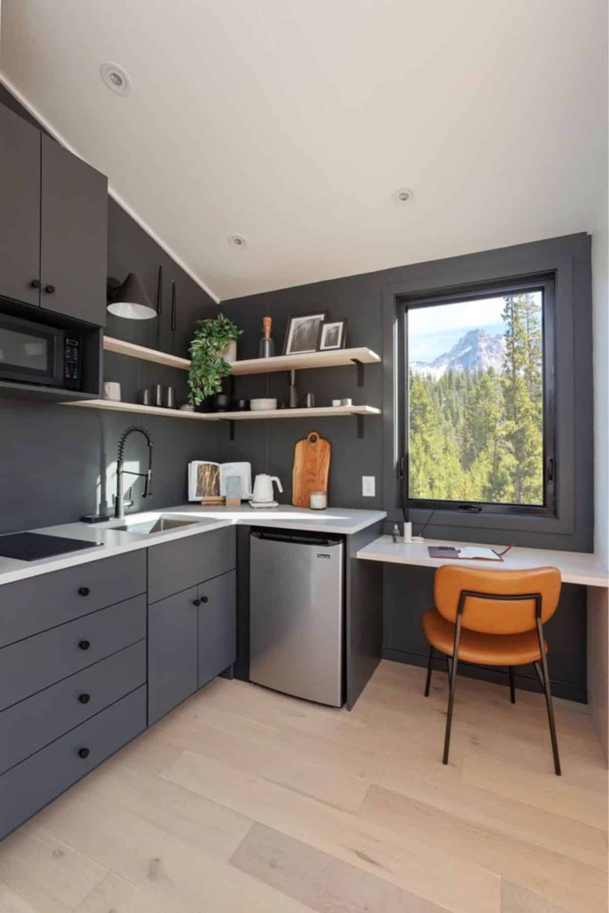 L shaped kitchen area plus separate dining cum workplace area of A-frame tiny home