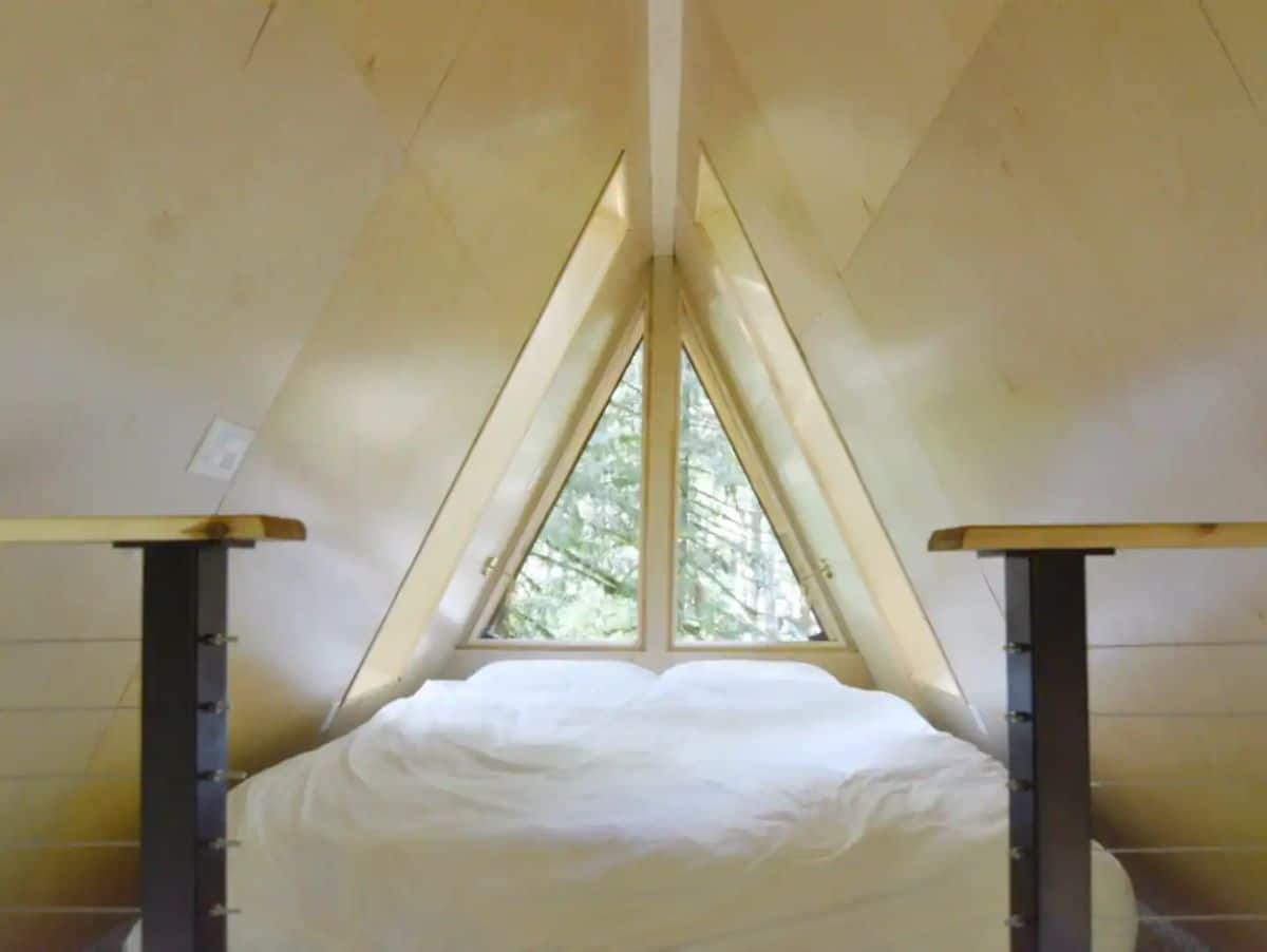 bed in loft with white ceiling