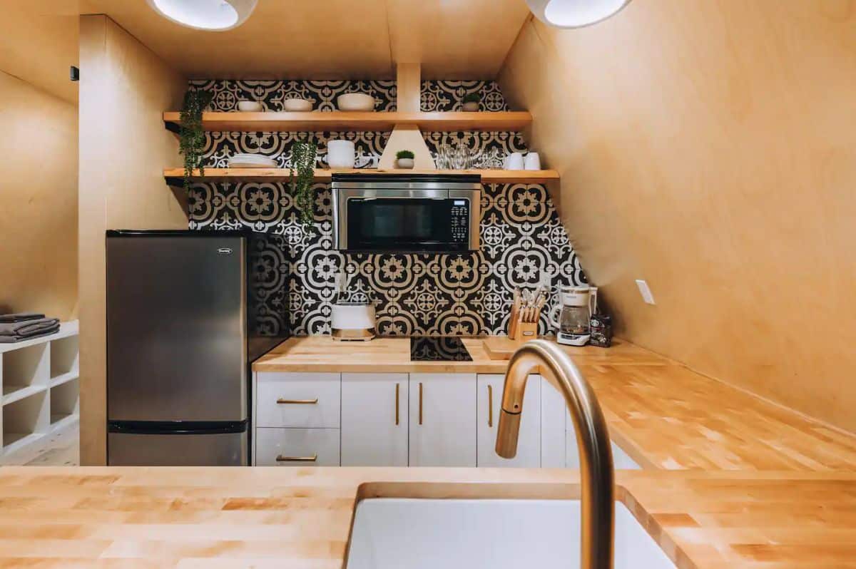 black and white tile backsplash in kitchen with butcher block counters