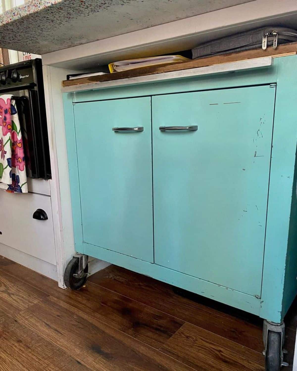 light teal cabinet underneath countertop