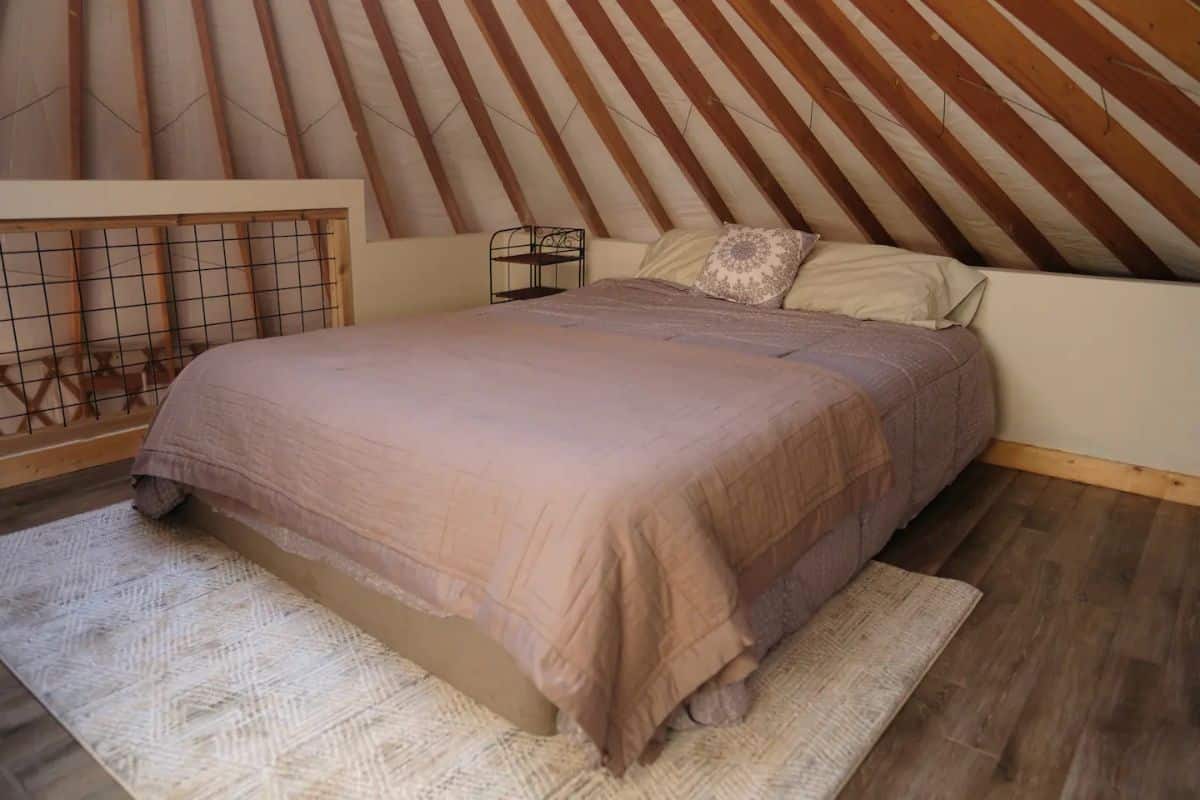 bed against wall of yurt top level