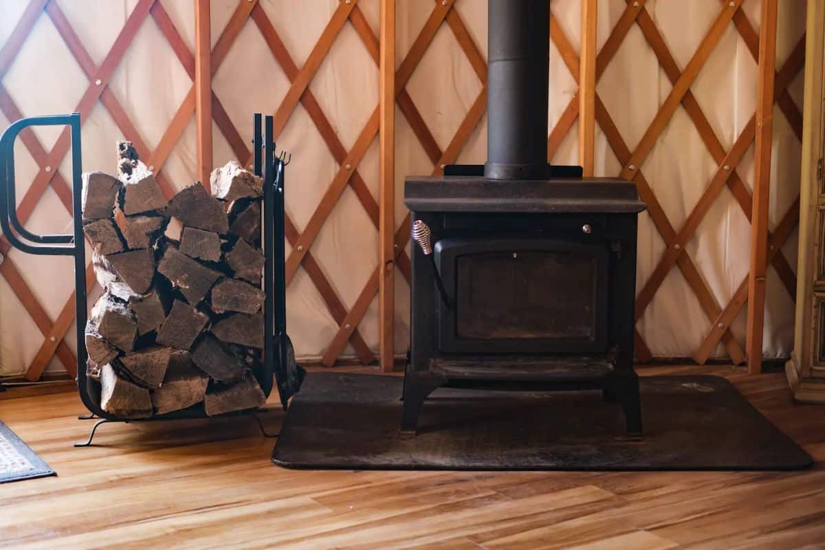 wood stove against lattice wall inside yurt