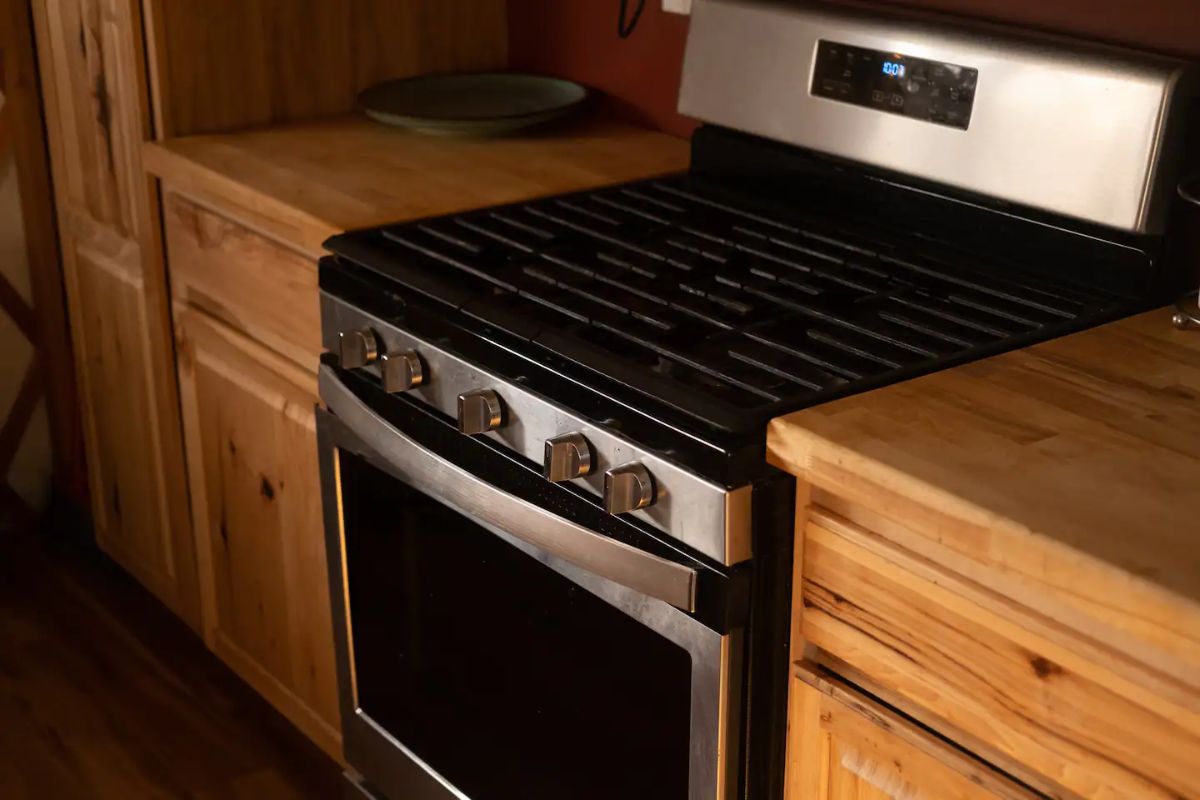 stainless steel stove in wood cabinet in kitchen