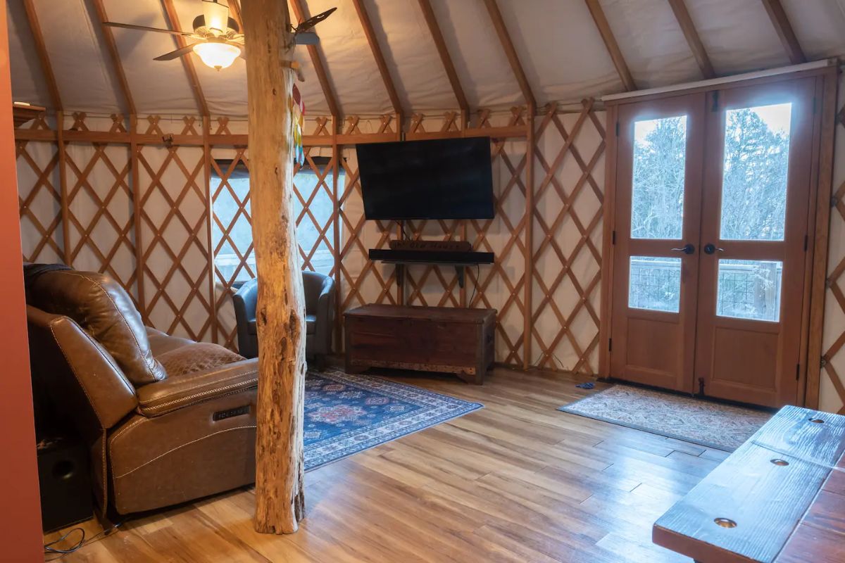 tv mounted against wall in yurt living area