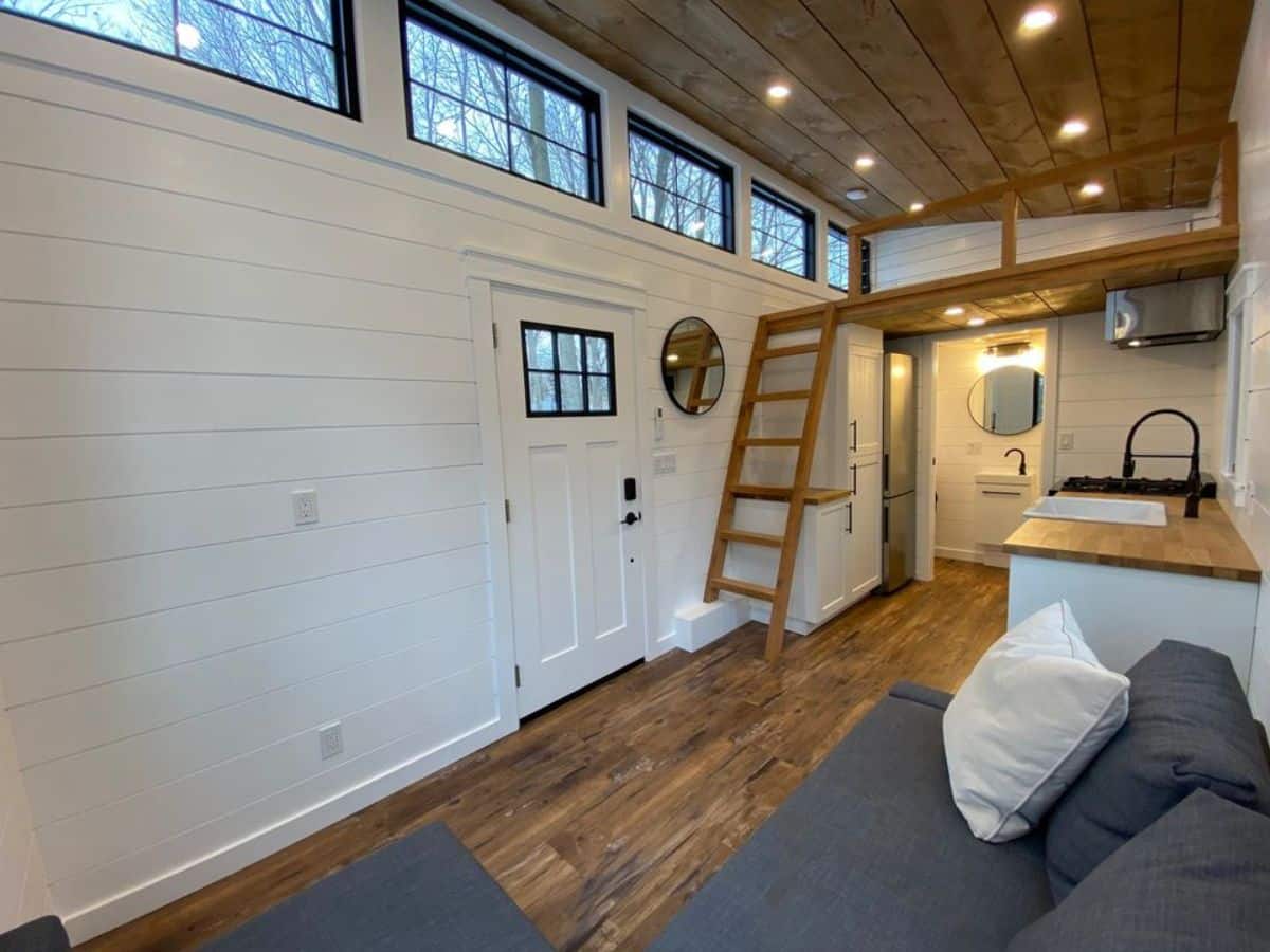 White wooden interiors of new luxurious tiny home from living area