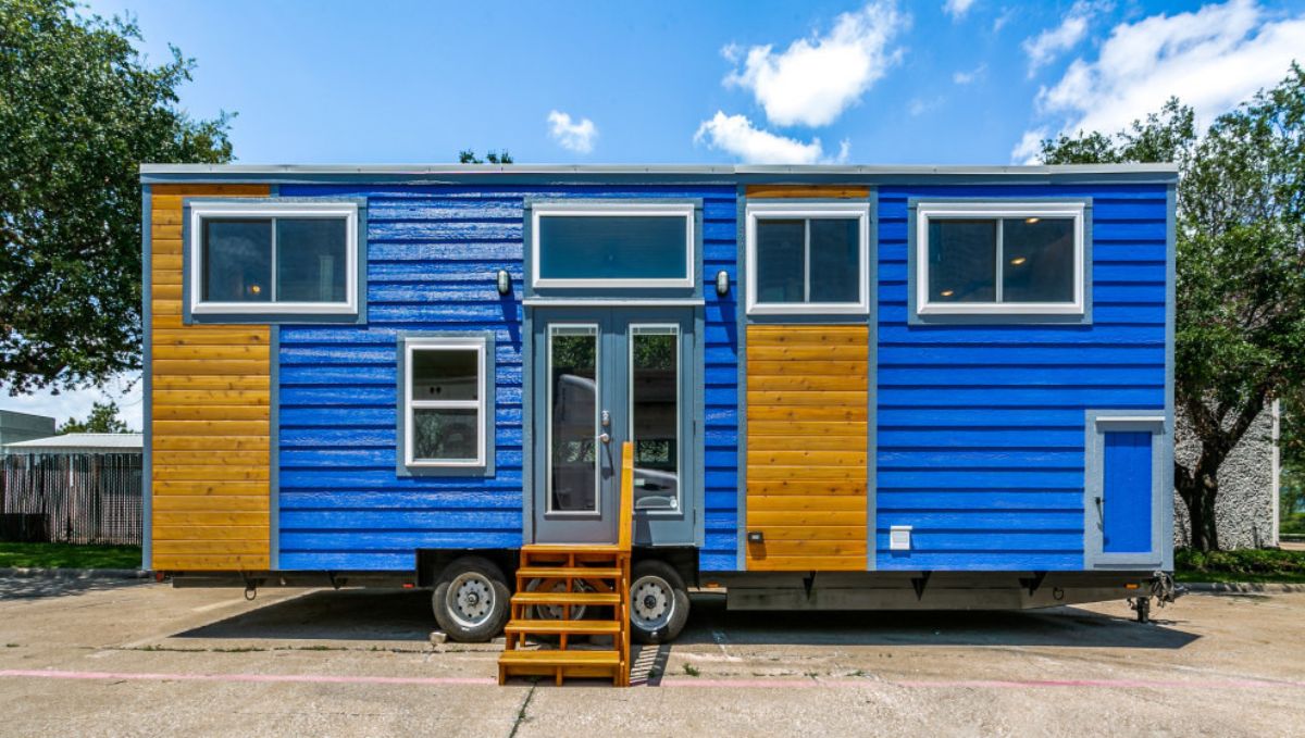 blue siding with wood accents on outside of chuy's house tiny home