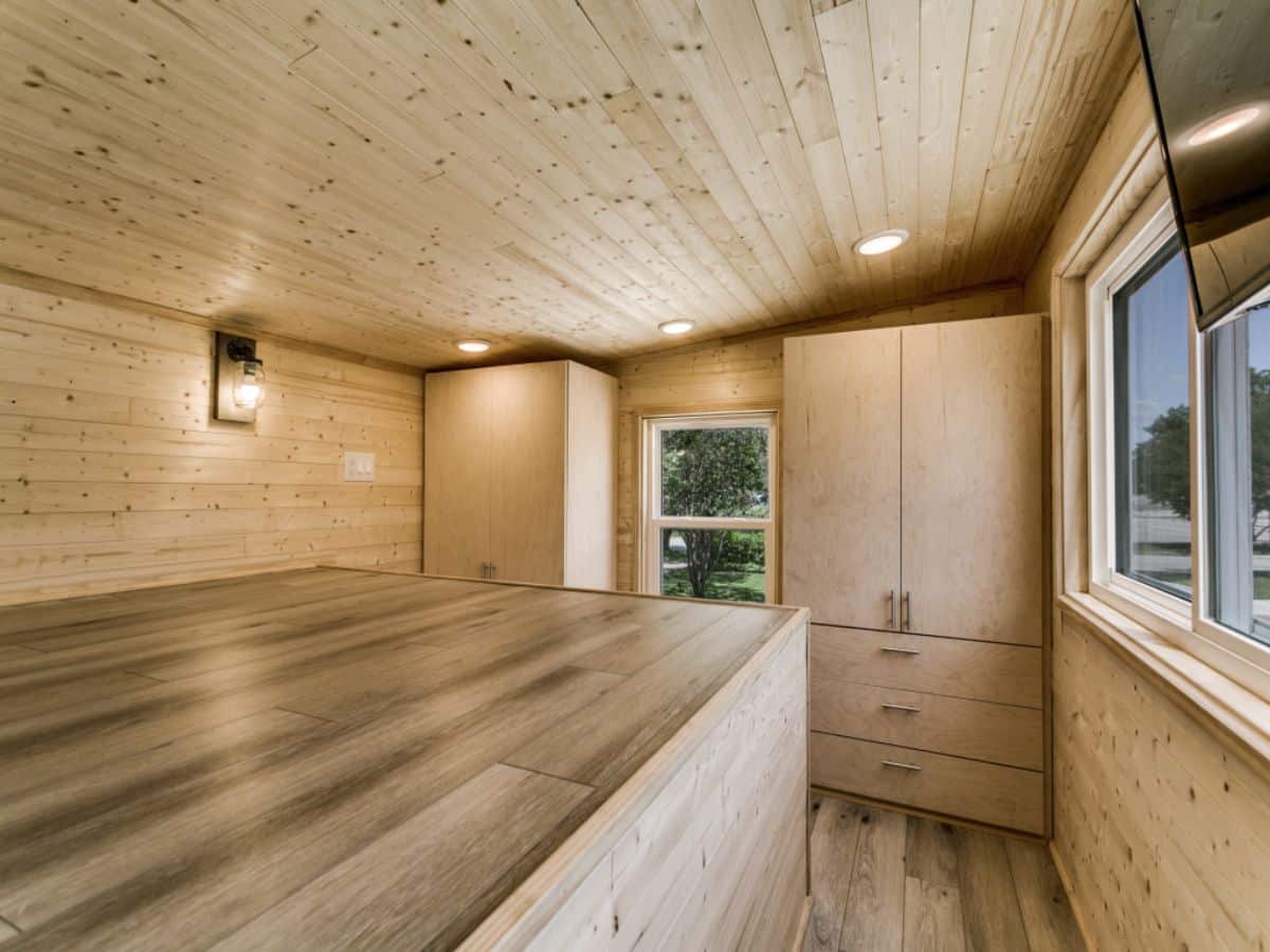 two wardrobe against end wall of tiny home loft
