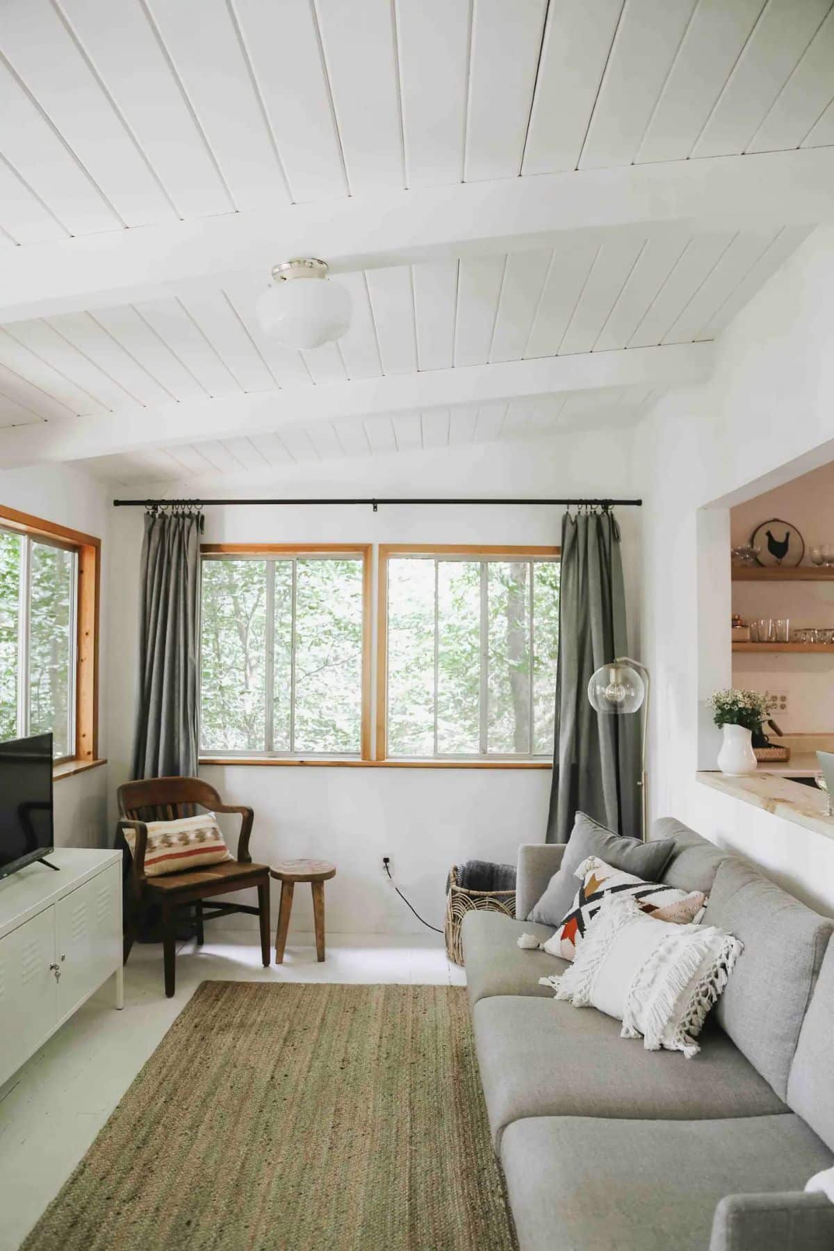 gray sofa against wall of cabin living room