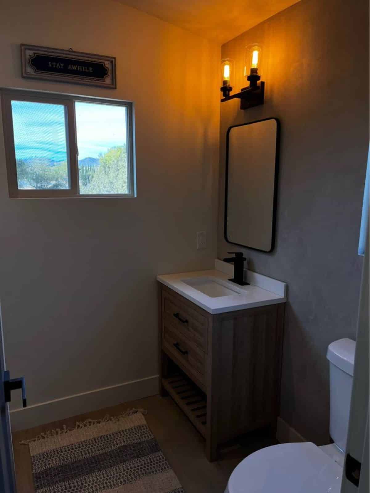 Bathroom of exquisite tiny home has all the standard fittings