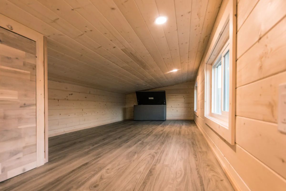long loft with light wood walls and floor