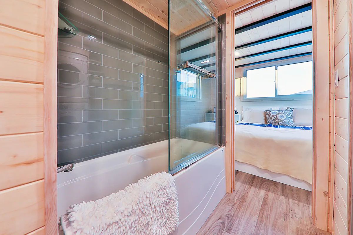 bathtub with glass shower door