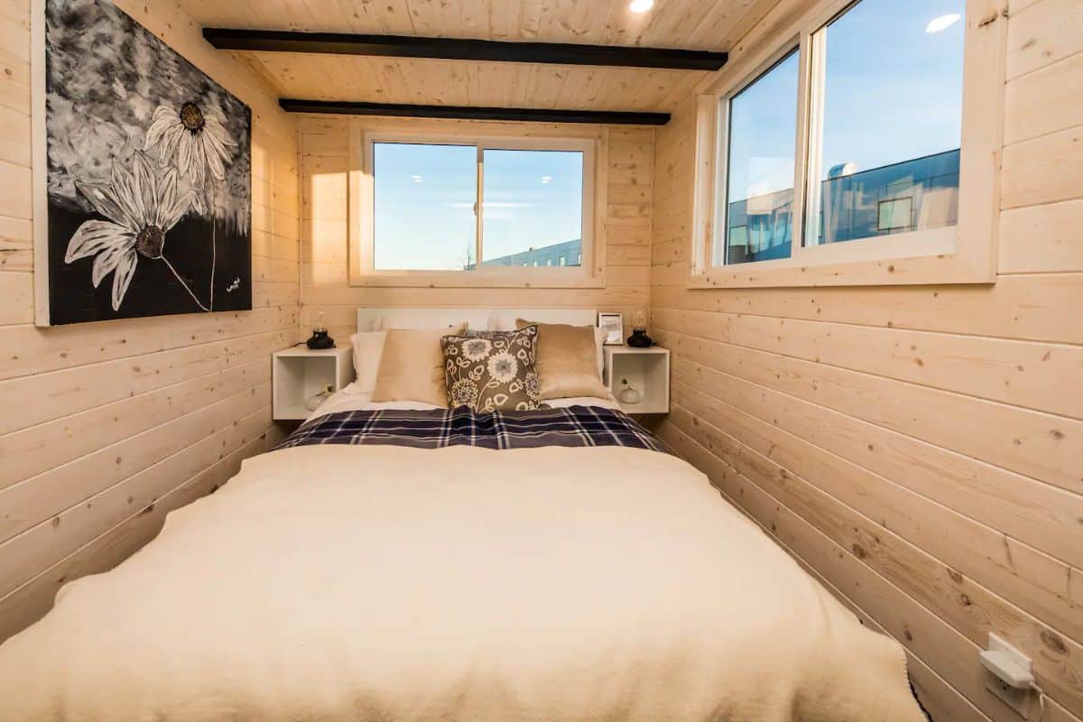 white bedding on bed in tiny home bedroom on main floor