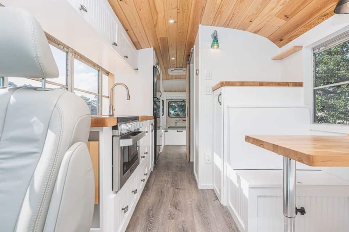 white cabinets on both sides of tiny home bus