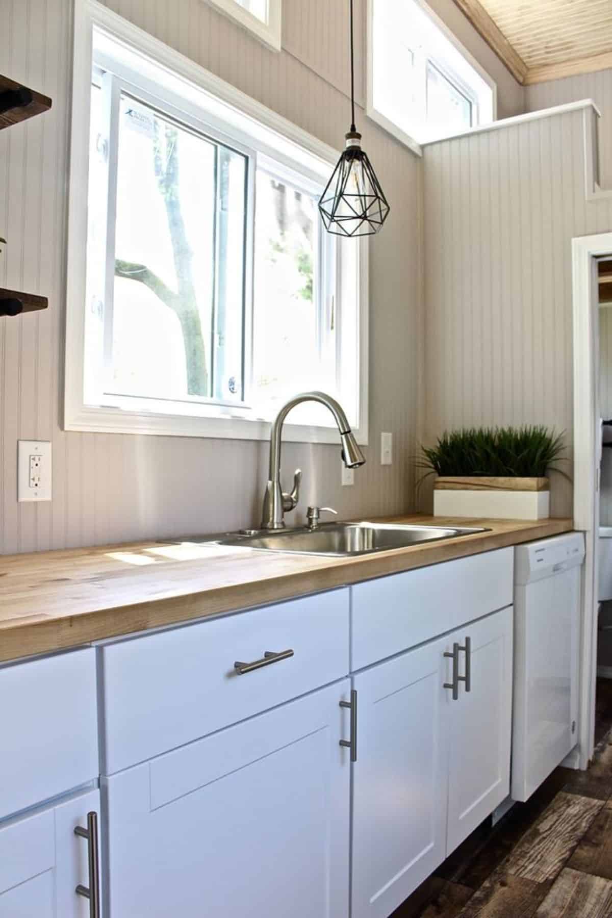 Sink with cabinets in kitchen area of NOAH certified tiny home