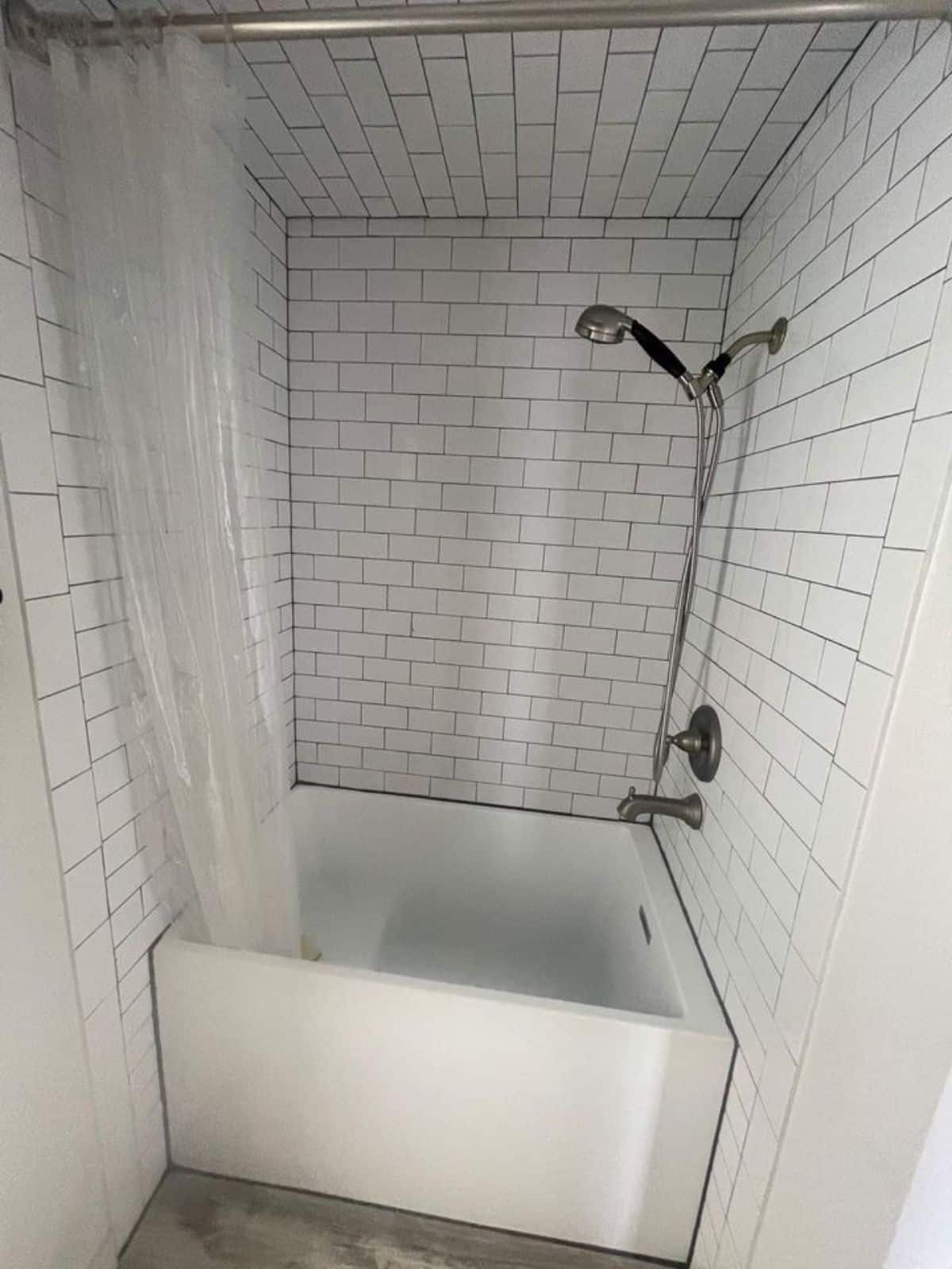 Fully tiled shower area in bathroom of offgrid container home