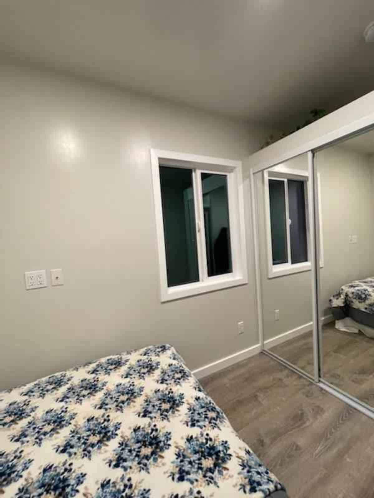 Bedroom is classic with bed and huge mirror wardrobe