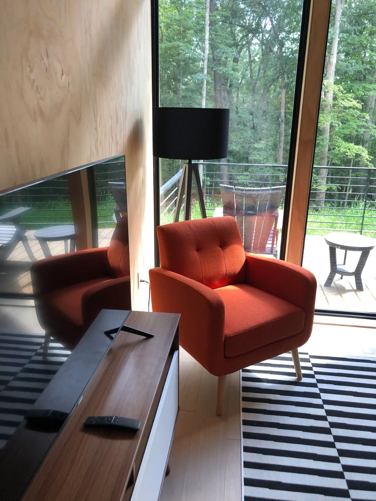 red chair by table and glass door to balcony