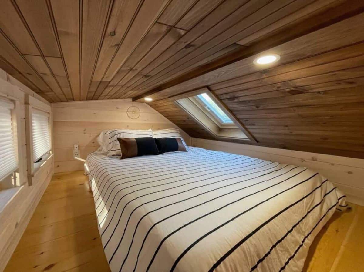 striped bedding on mattress in loft bedroom