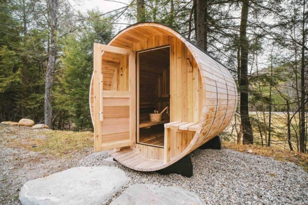 round sauna with door open sitting on gravel driveaway