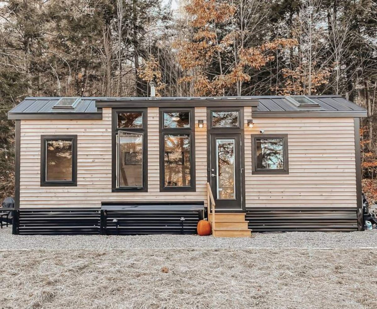 front of tiny home with tall windows and glass door
