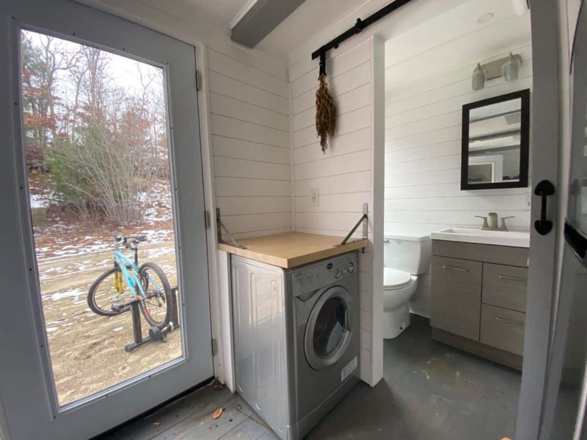Washing machine right next to the main door of solar powered tiny home