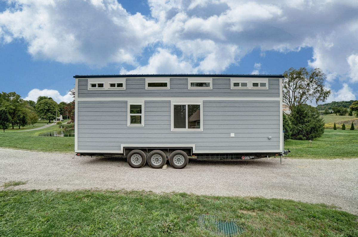 side of gray tiny house with white trim