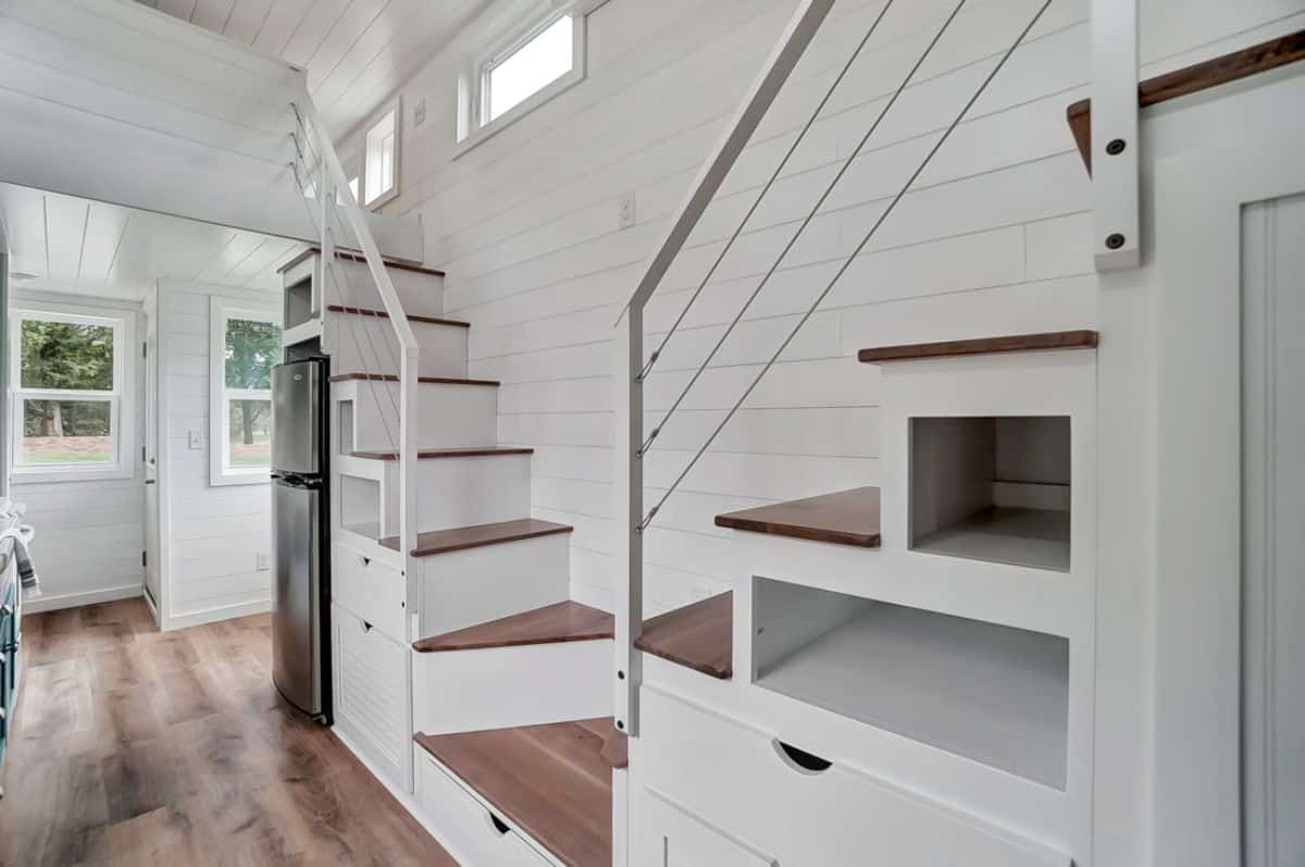 open shelves under stairs with storage