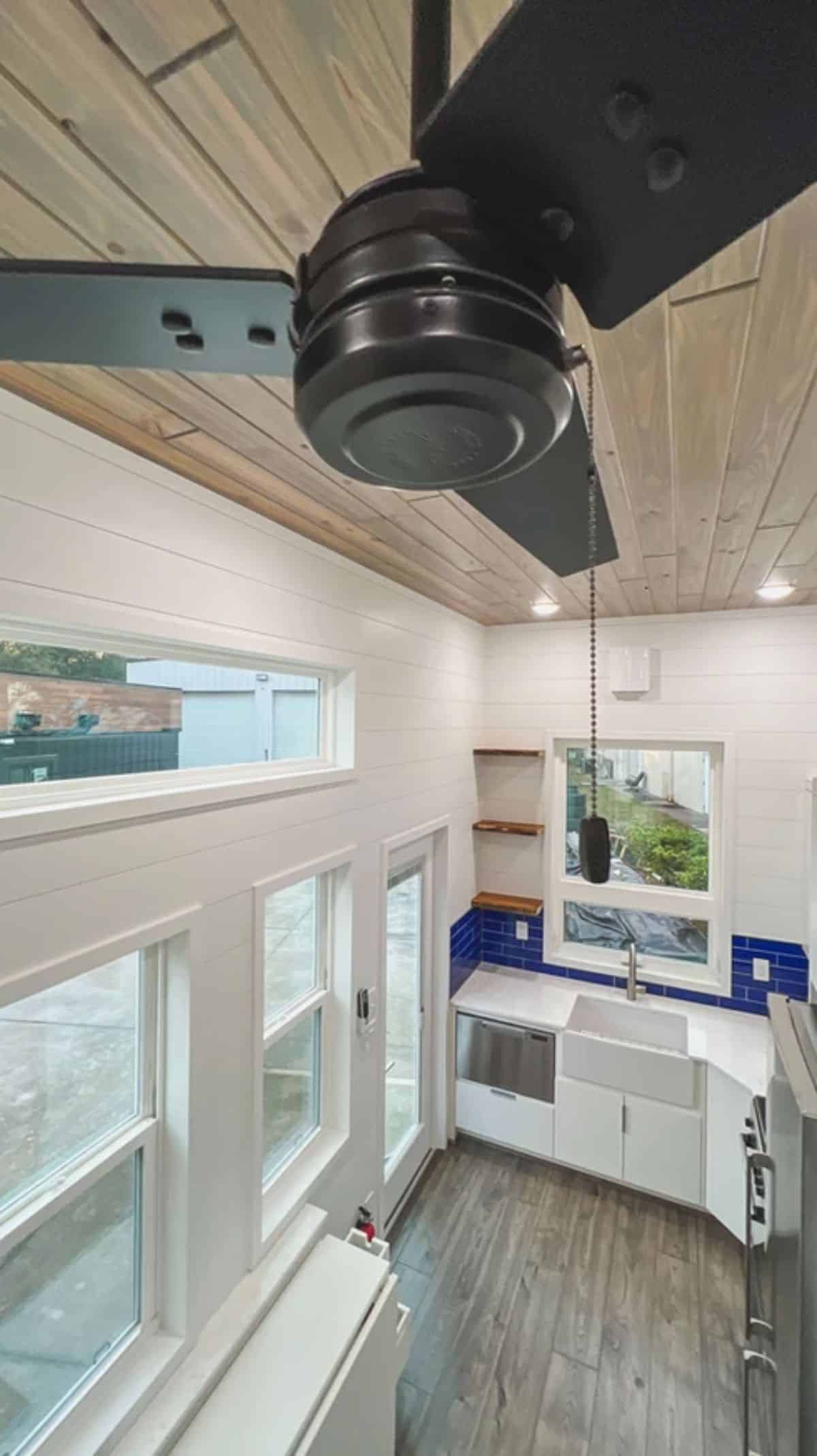 black ceiling fan in middle of ceiling above tiny home living room