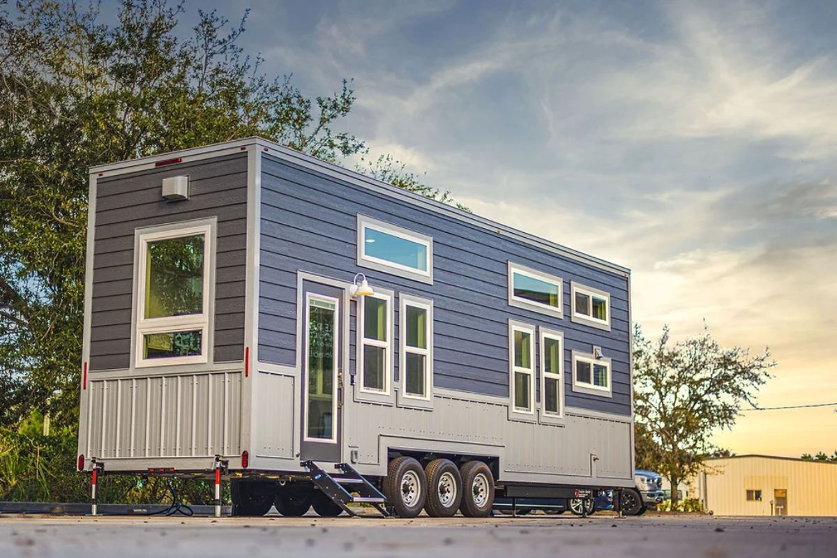 door side of gray and white tiny home on wheels